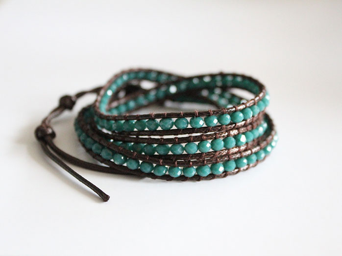 Leather-wrapped bracelet with blue beads.