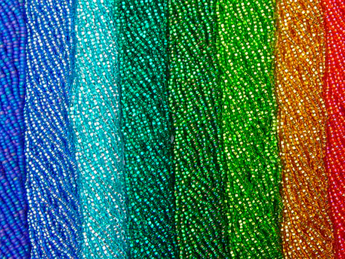 Thousands of tiny beads arranged from blue to red.