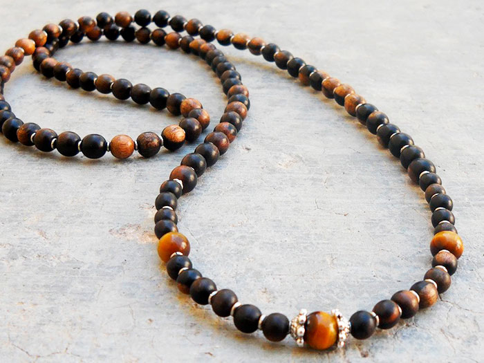 A long beaded necklace with brown beads.